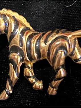 Vintage gold tone zebra brooch with turquoise eyes